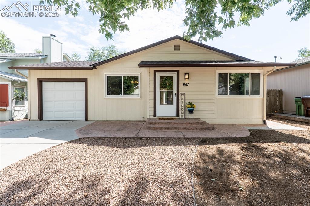 Caption: Ranch-style house featuring a garage, concrete driveway, and roof with shingles