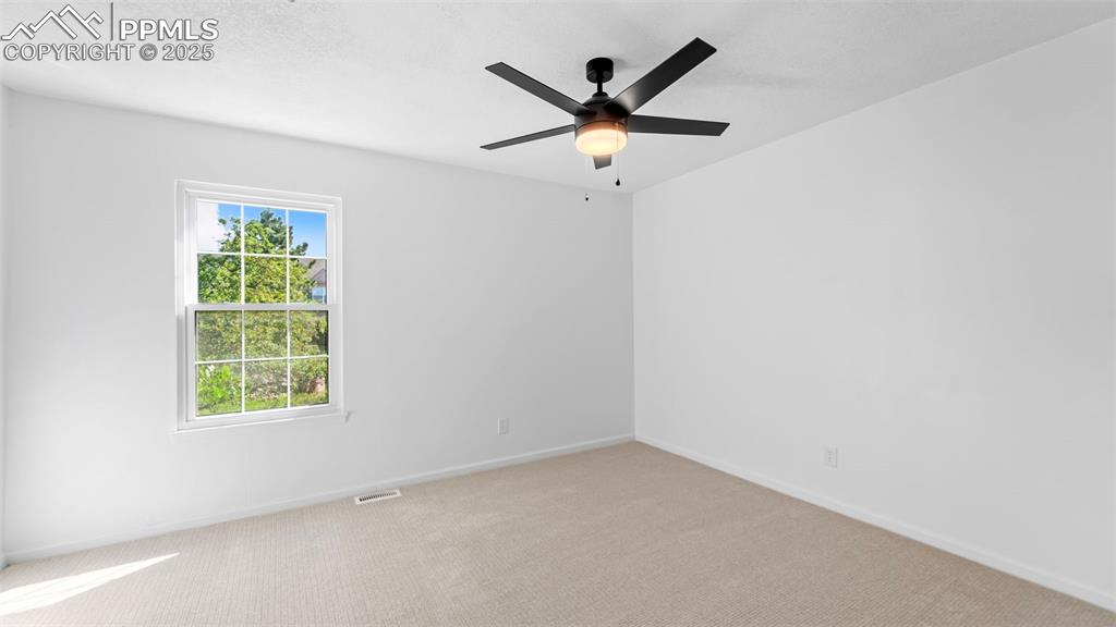 Image 12 of 21: Empty room featuring carpet and ceiling fan