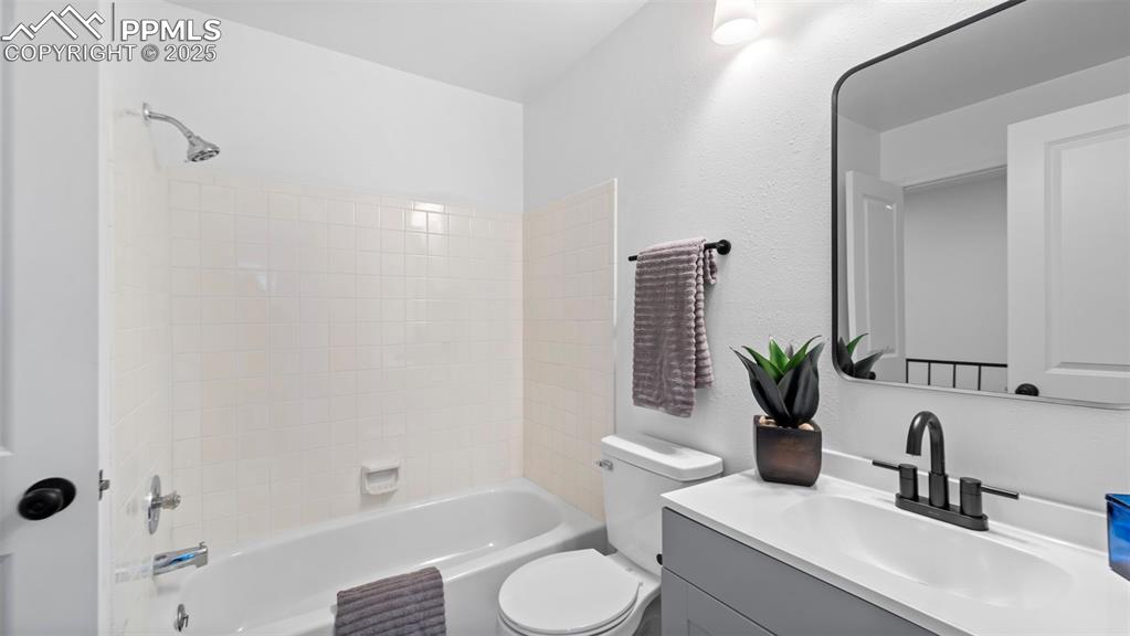 Image 15 of 21: Bathroom with shower / bathtub combination and vanity