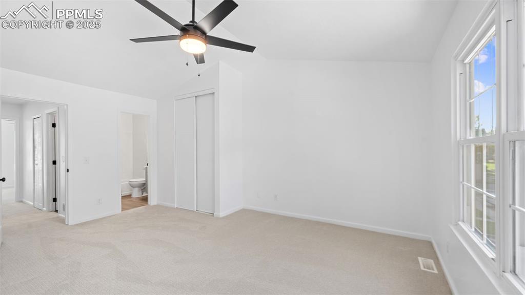 Image 17 of 21: Unfurnished bedroom featuring light colored carpet, lofted ceiling, ceiling