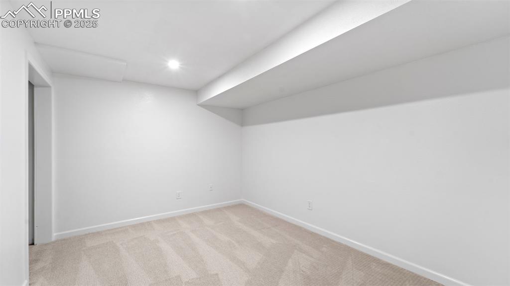 Image 19 of 21: Below grade area featuring light carpet and recessed lighting