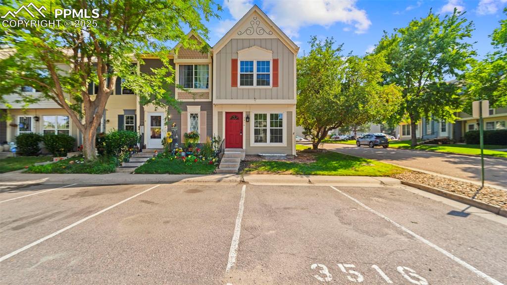 Image 2 of 21: View of front of house featuring board and batten siding and uncovered park