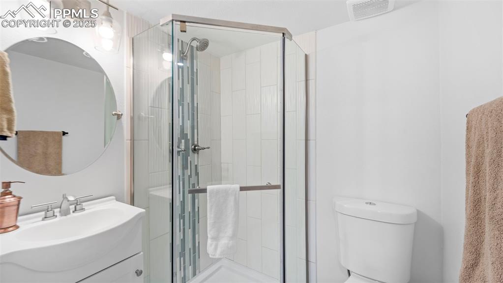 Image 20 of 21: Full bathroom featuring vanity and a stall shower