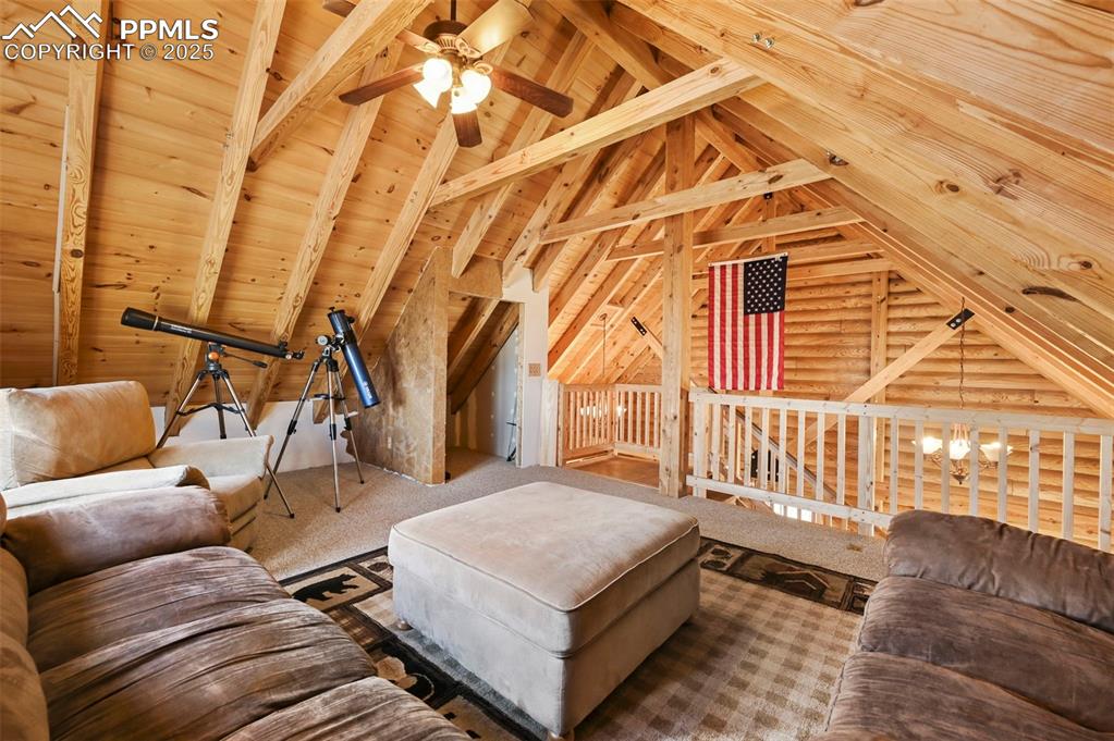 Image 17 of 35: Living room featuring a ceiling fan, wooden ceiling, and carpet