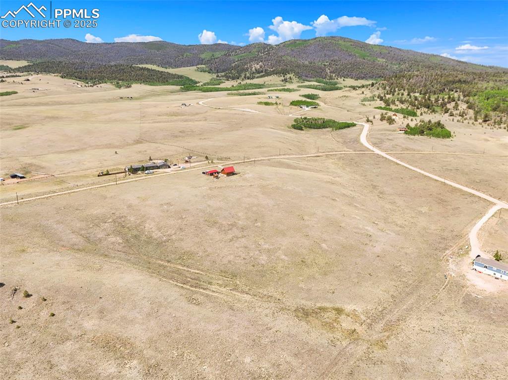 Image 30 of 35: Aerial view of sparsely populated area with mountains