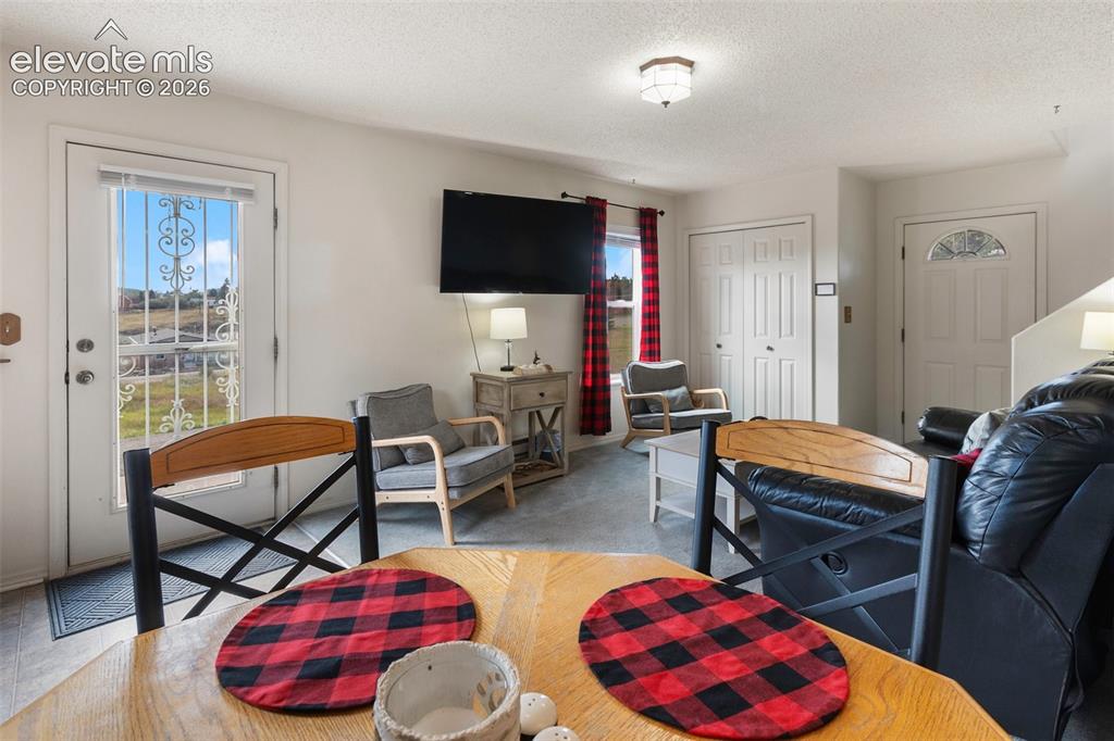 Image 13 of 36: Dining area with an open floor plan feel to the living room and kitchen. 