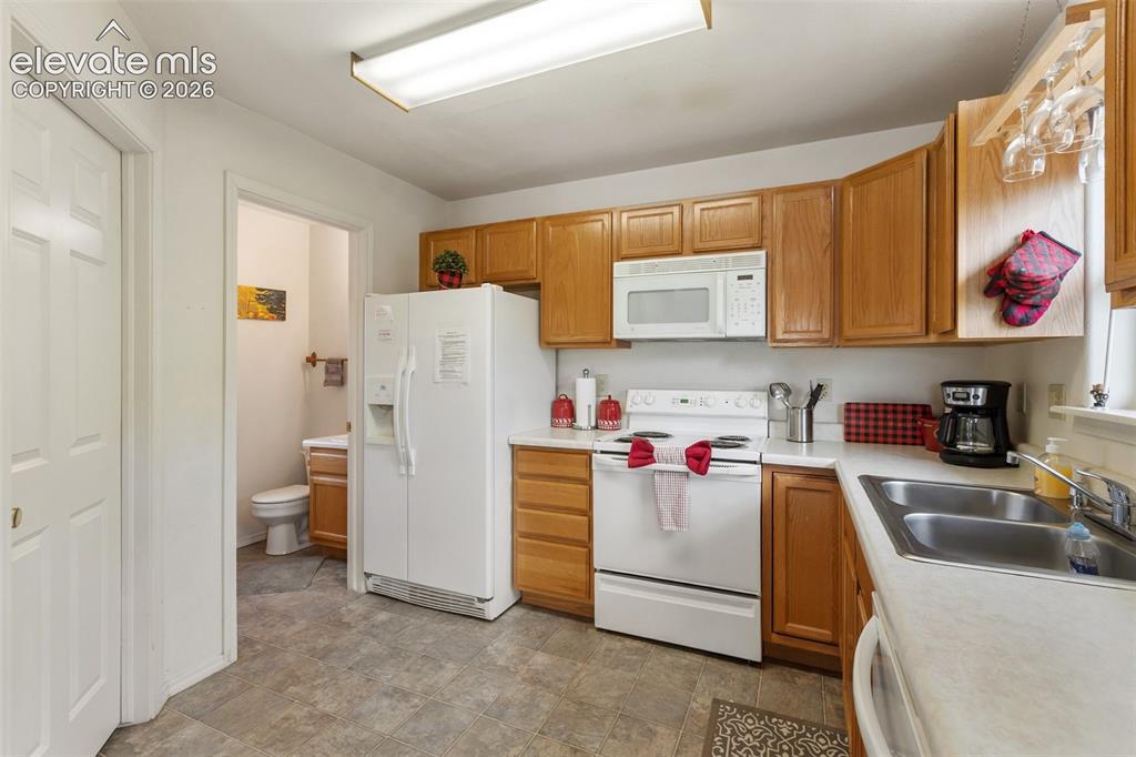 Image 20 of 36: Half bath and laundry on main level.