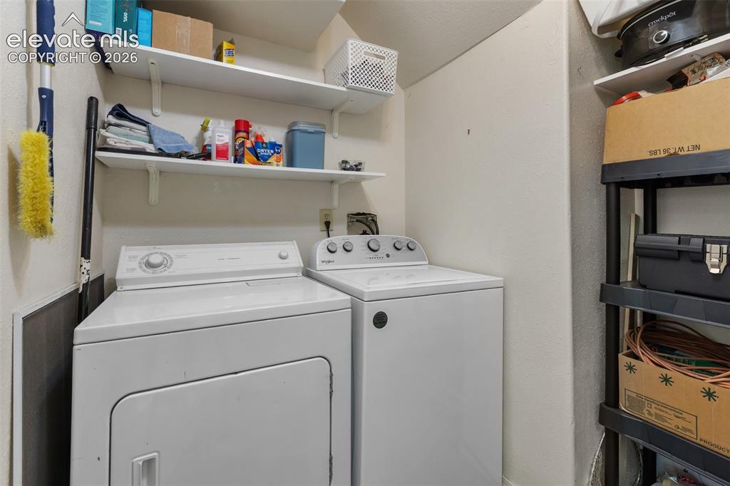 Image 22 of 36: Large laundry space on main level with extra storge and pantry space. 