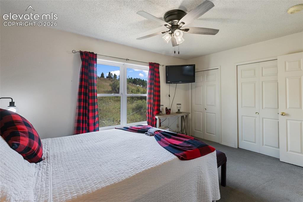 Image 24 of 36: Primary Bedroom with hillside views.