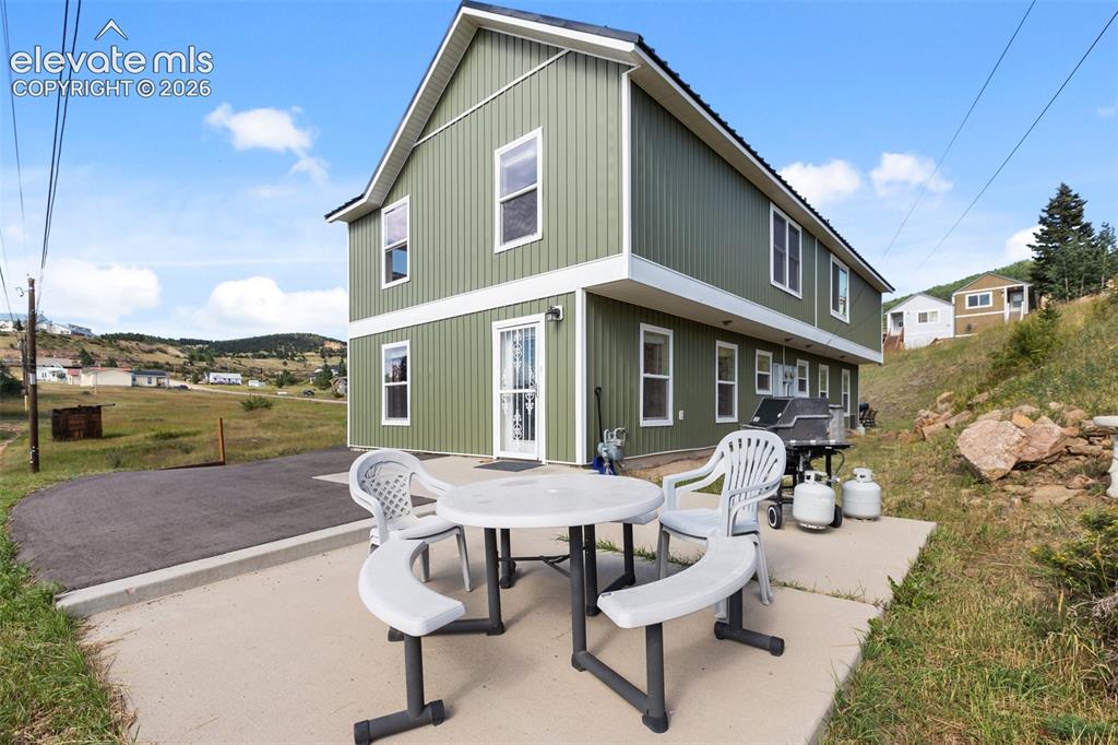 Image 5 of 36: Walkout to patio with an outside picnic and BBQ area. 