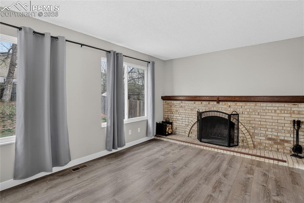 Image 7 of 20: Family room w/ fireplace