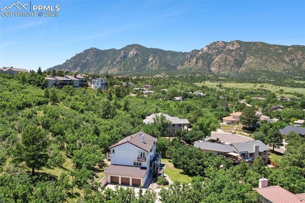 Image 43 of 49: Aerial perspective of suburban area featuring a mountain backdrop