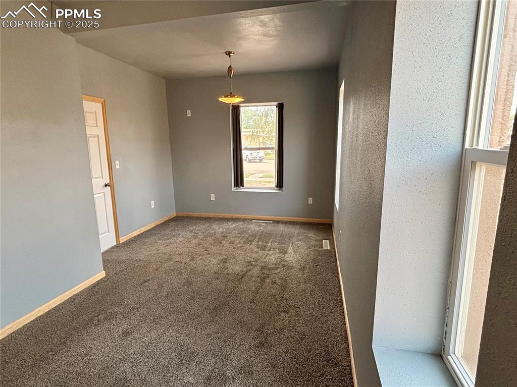 Image 15 of 35: Carpeted spare room featuring baseboards