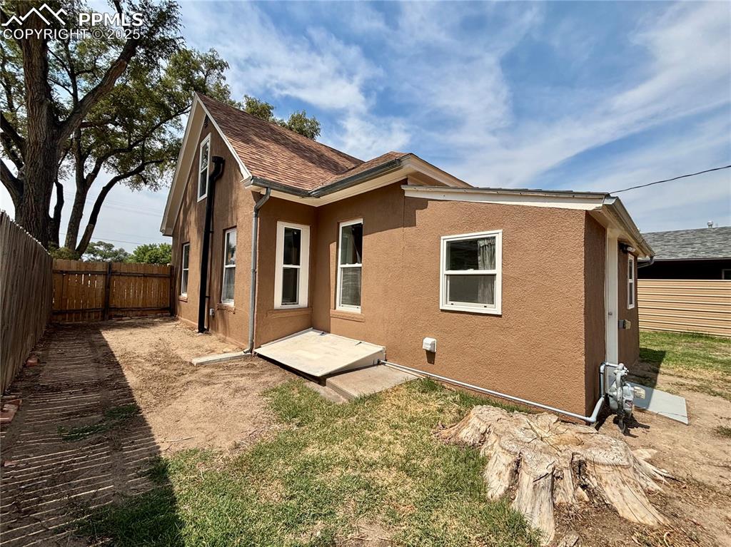 Image 29 of 35: Rear view of house with a fenced backyard, stucco siding, a patio, and a sh