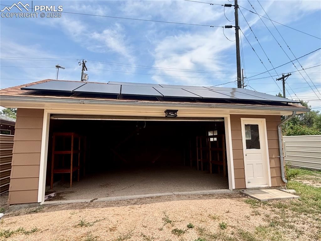 Image 34 of 35: Detached garage with solar panels