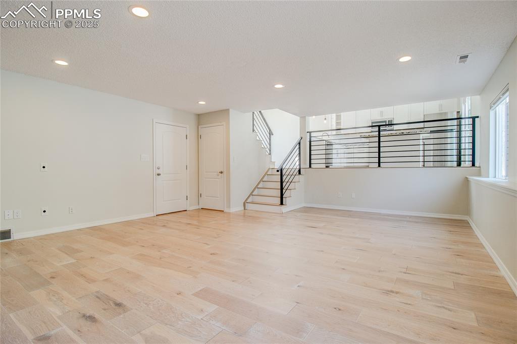 Image 22 of 32: Unfurnished living room with recessed lighting, light wood finished floors,