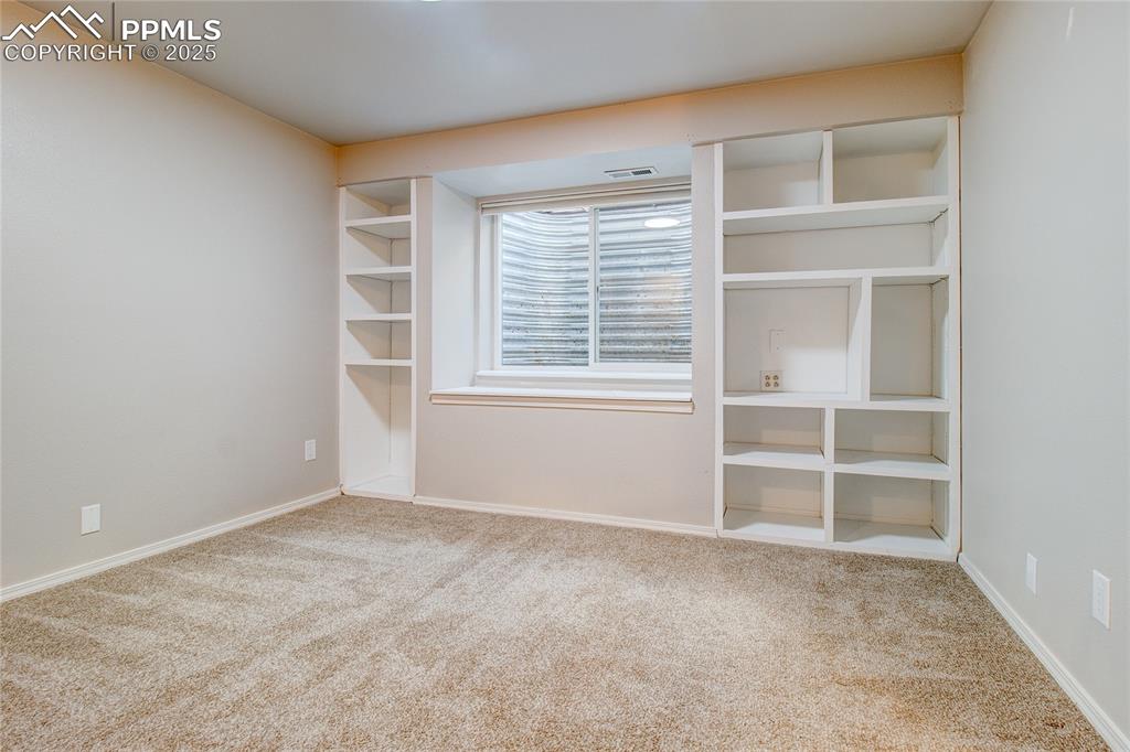 Image 24 of 32: Carpeted spare room with baseboards