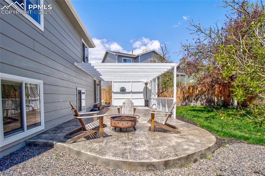 Image 30 of 32: View of patio / terrace with a fire pit and a pergola