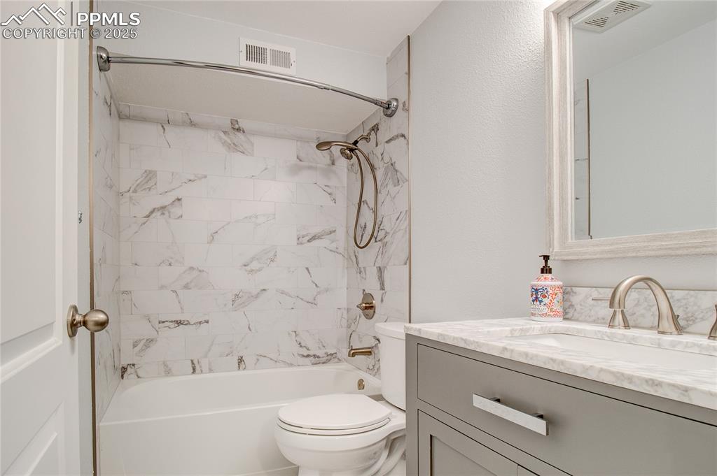 Image 5 of 32: Full bathroom with vanity and shower / bathtub combination