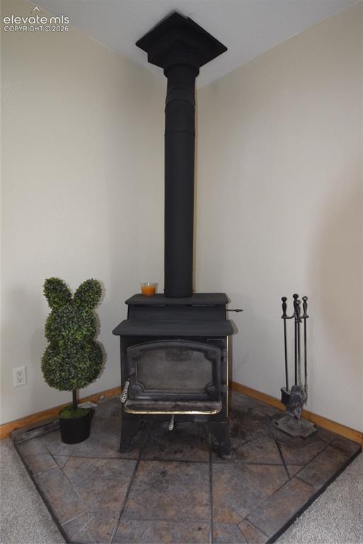 Image 14 of 48: Freestanding wood-burning stove with a matte black finish