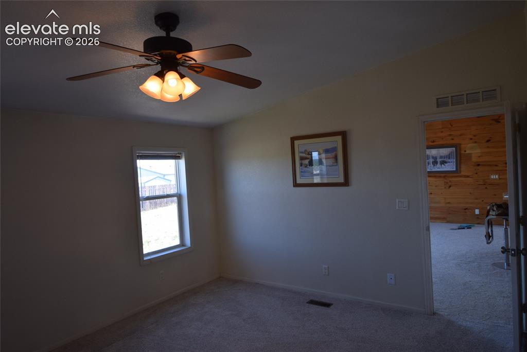 Image 30 of 48: Vaulted ceiling with a ceiling fan and integrated lighting, single window,