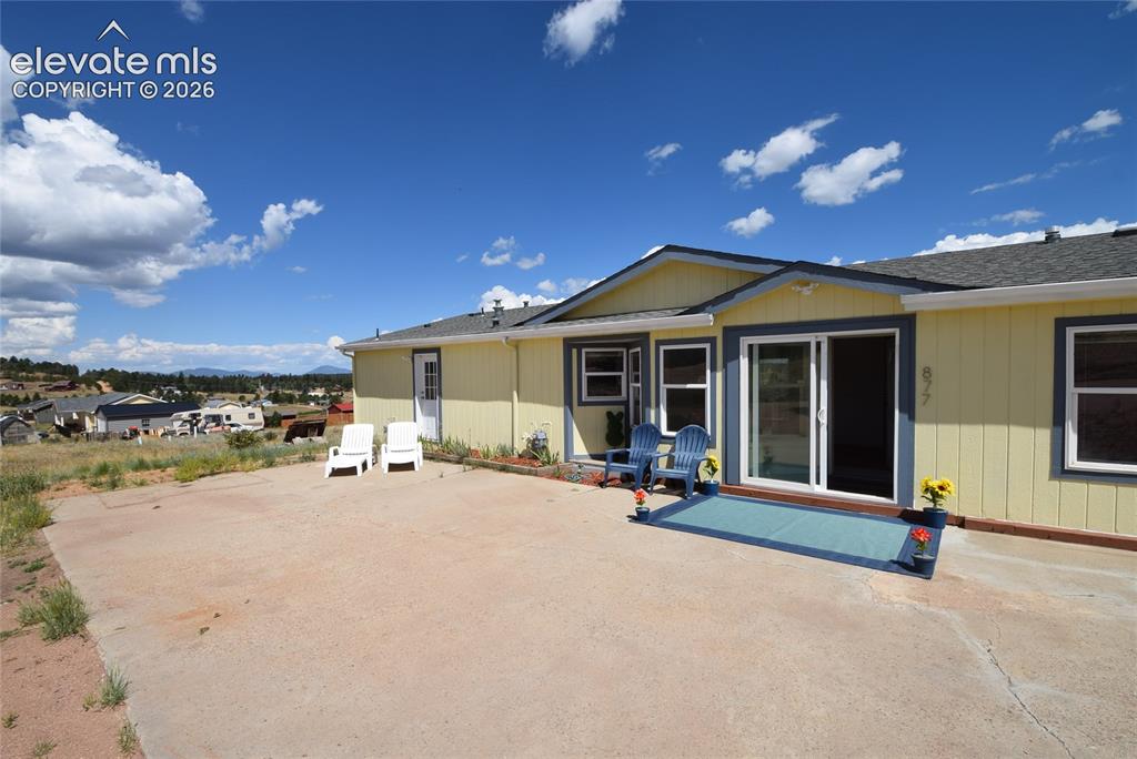 Image 4 of 48: Expansive concrete patio with direct outdoor access via sliding glass doors