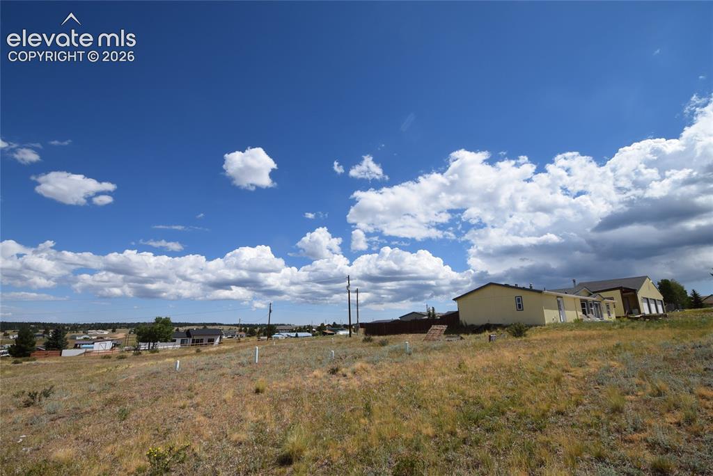 Image 42 of 48: Expansive undeveloped lot featuring natural ground cover, a gentle slope, a