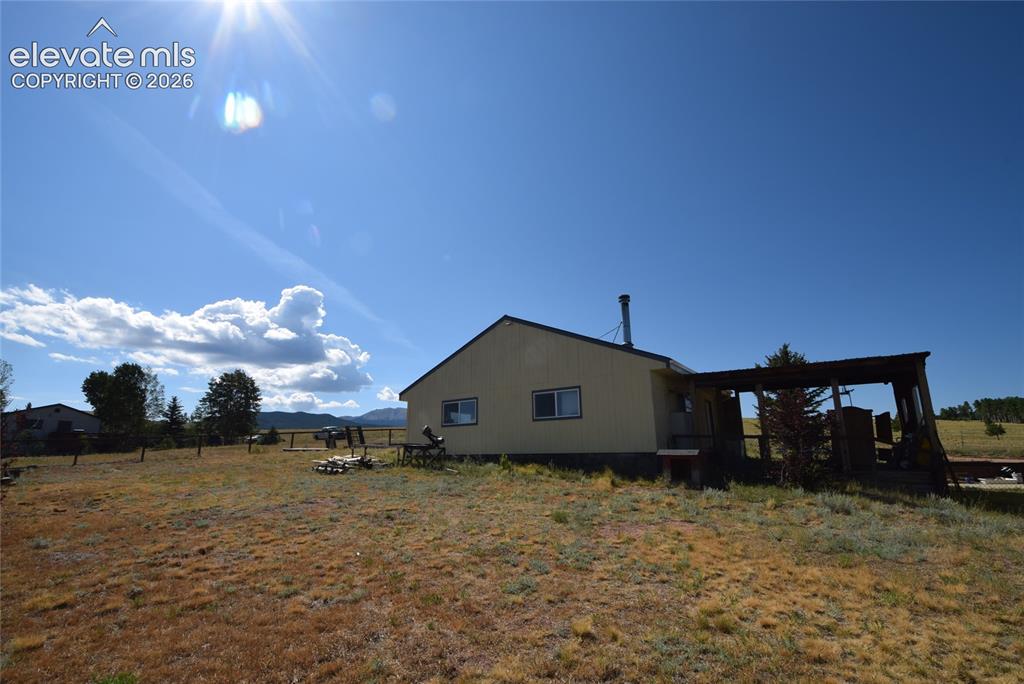 Image 5 of 48: Property featuring a light-colored exterior, an attached covered porch, a p