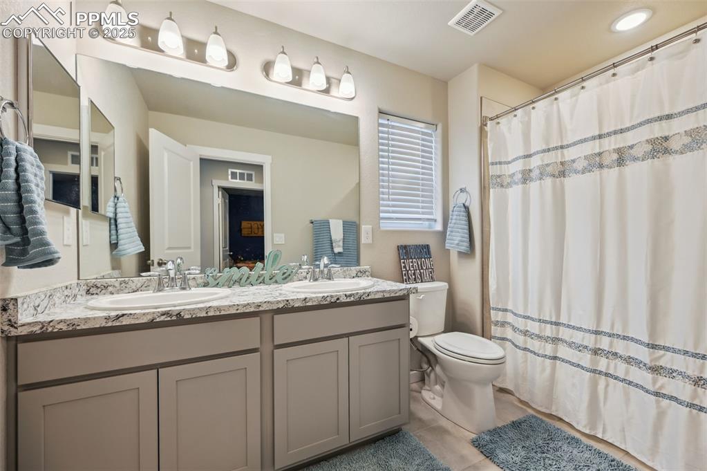 Image 16 of 46: Full bathroom featuring double vanity