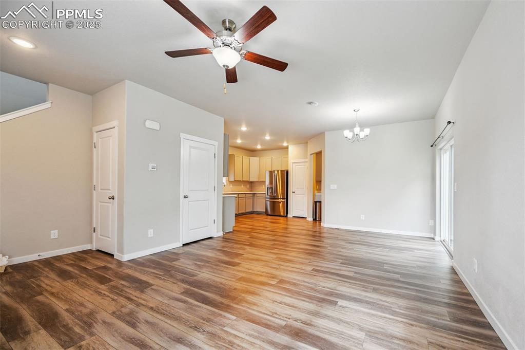Image 29 of 46: Unfurnished living room featuring a chandelier, light wood-style floors, a