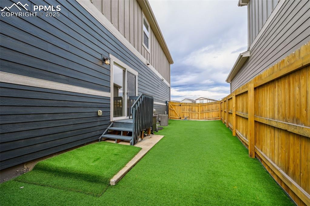 Image 31 of 46: View of fenced backyard