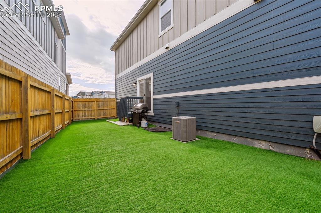 Image 32 of 46: View of fenced backyard