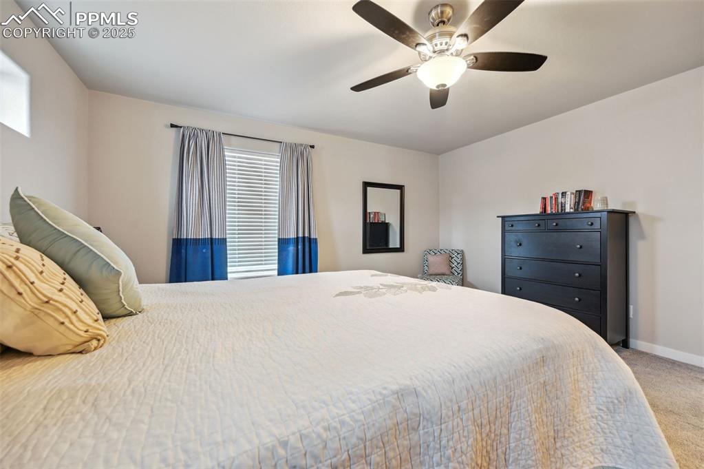 Image 8 of 46: Bedroom with light carpet and ceiling fan