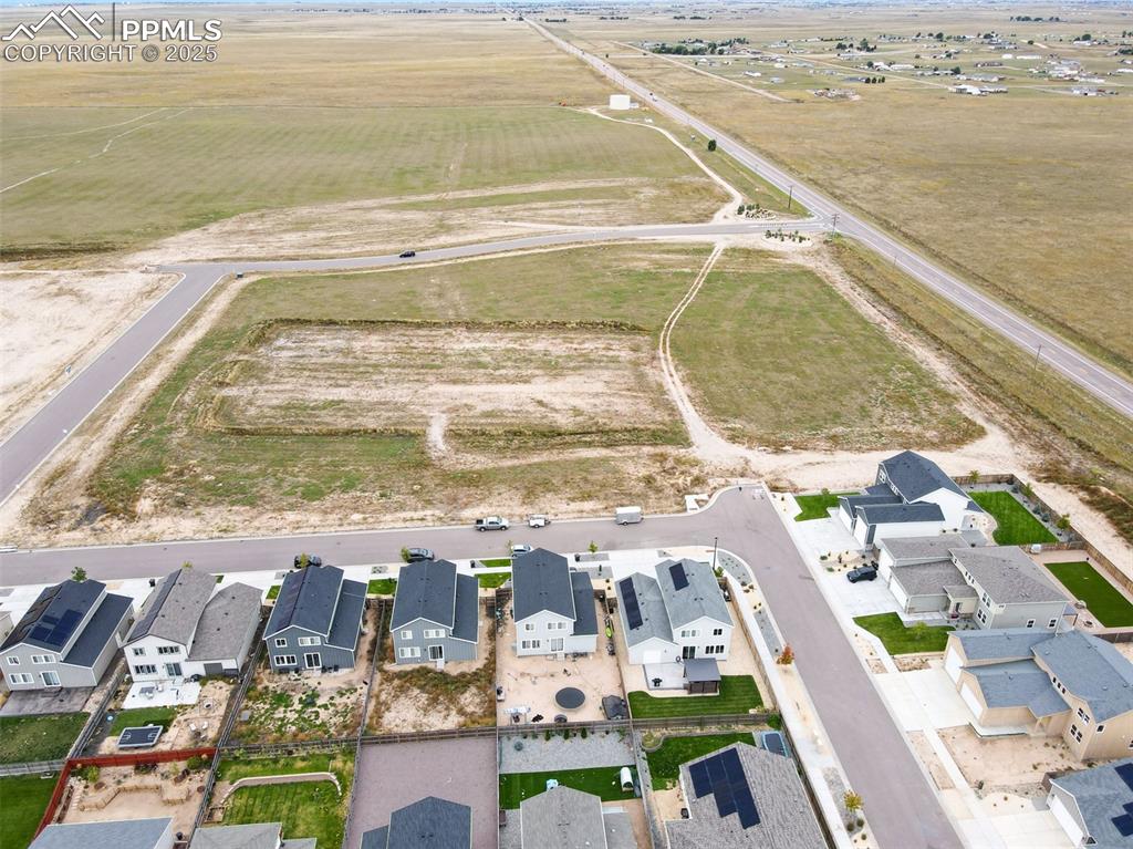 Image 17 of 50: Aerial view of sparsely populated area with nearby suburban area