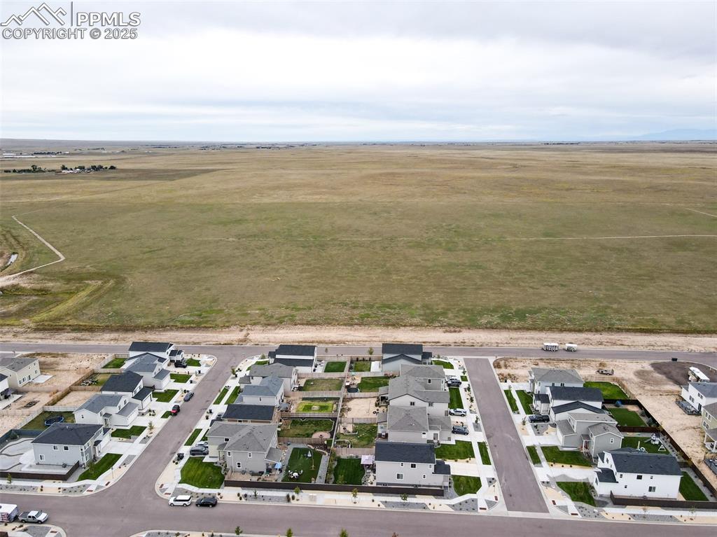 Image 19 of 50: View of property location with nearby suburban area and rural landscape