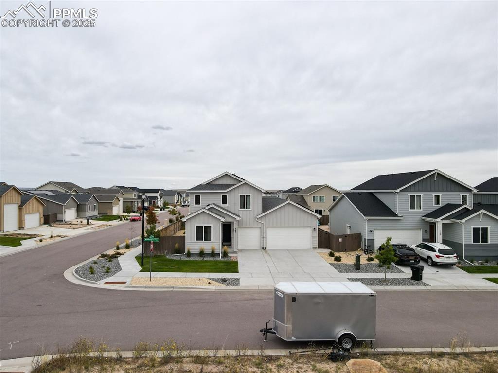Image 3 of 50: View of asphalt street featuring a residential view and curbs