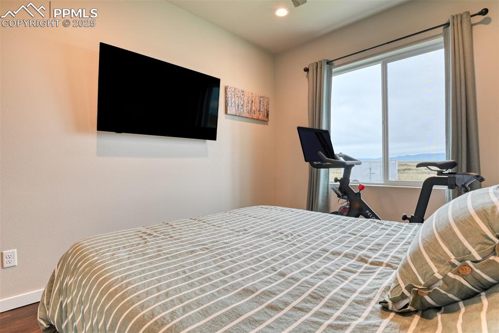 Image 32 of 50: Bedroom featuring recessed lighting and wood finished floors