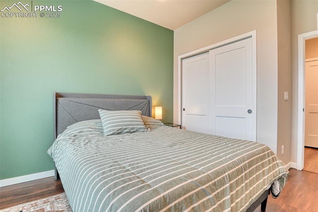 Image 33 of 50: Bedroom with a closet and dark wood-type flooring