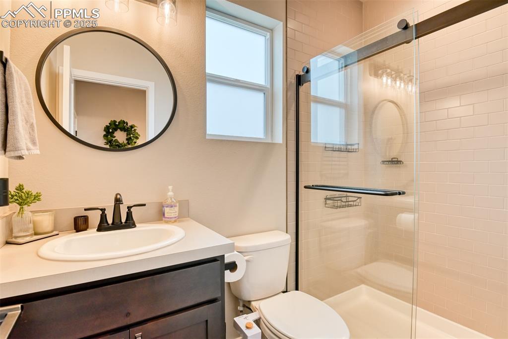 Image 36 of 50: Full bath featuring vanity and a shower stall