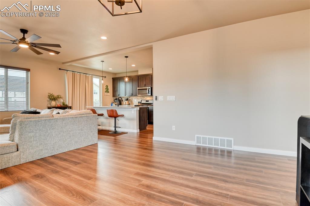 Image 38 of 50: Living room with recessed lighting, light wood finished floors, and ceiling