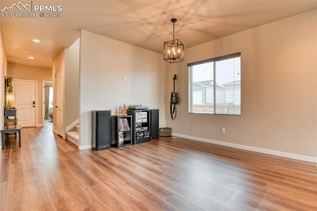 Image 40 of 50: Dining area with stairway, light wood-style floors, and recessed lighting