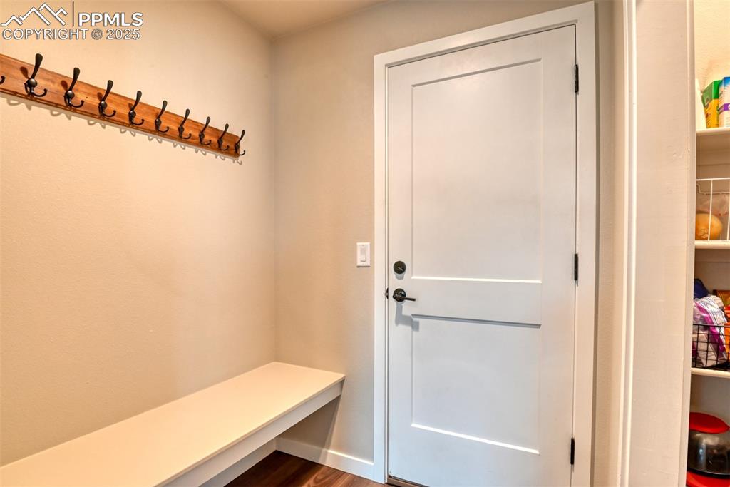 Image 49 of 50: Mudroom featuring dark wood-style flooring and baseboards