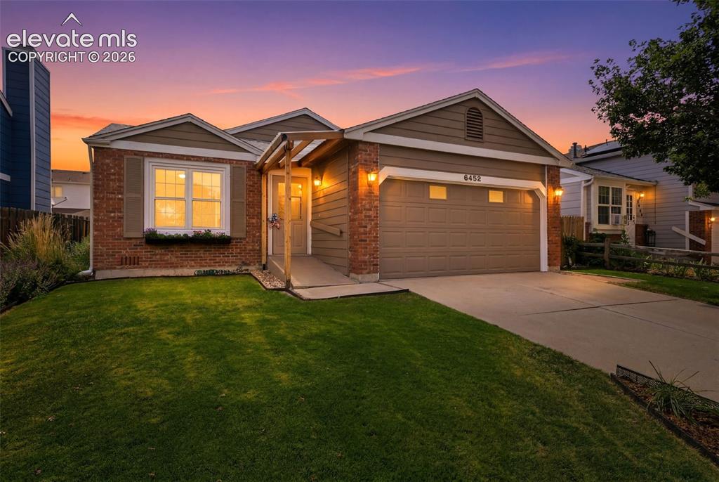 Image 1 of 49: The sun sets on this charming ranch home