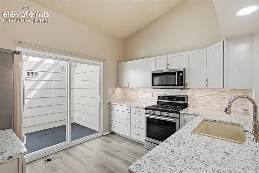 Image 12 of 49: Quartz countertops with oversized composite sink
