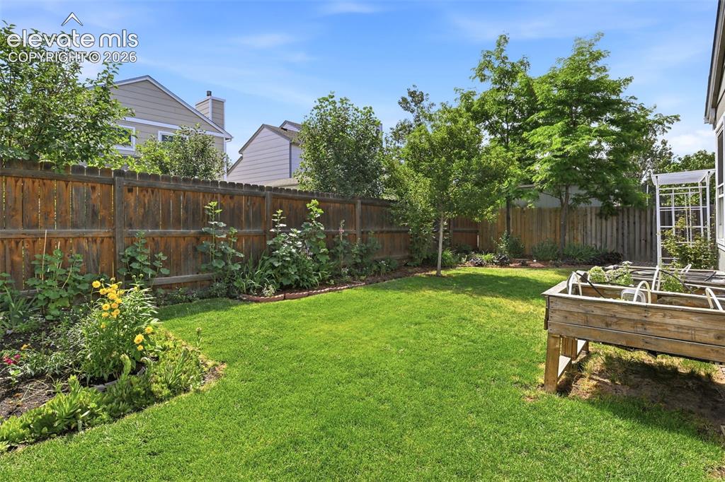 Image 24 of 49: Beautiful landscaping with raised garden beds
