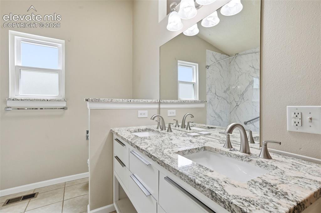 Image 29 of 49: Dual vanities and custom cabinets
