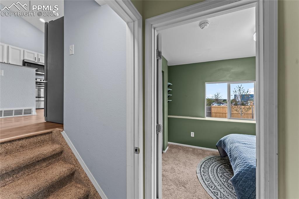 Image 17 of 30: lower level bedroom #3 and view of kitchen 