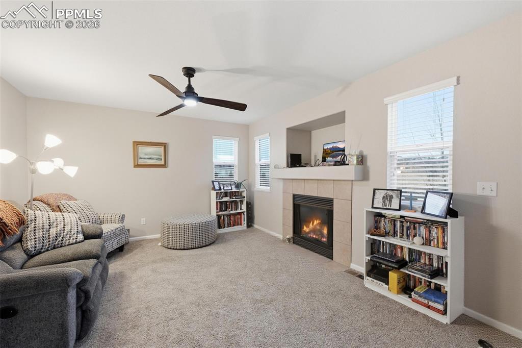 Image 6 of 18: Living room featuring gas fireplace