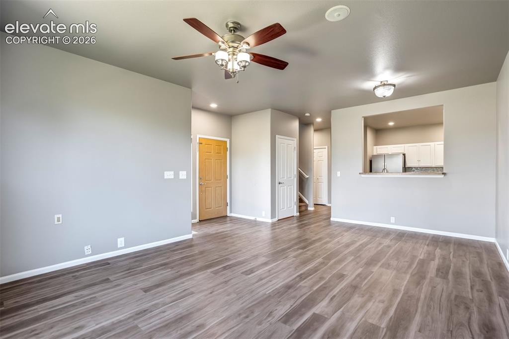 Image 7 of 50: Wood-finish flooring, ceiling fan with light fixture, recessed lighting, in