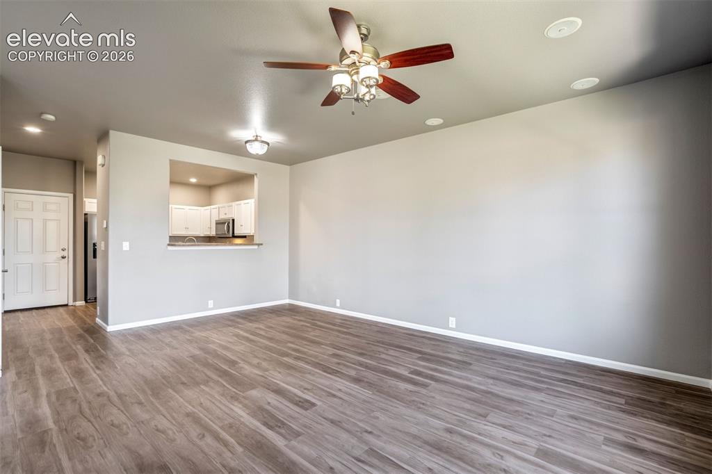 Image 8 of 50: Wood-finish flooring, recessed ceiling lighting, ceiling fan with light fix